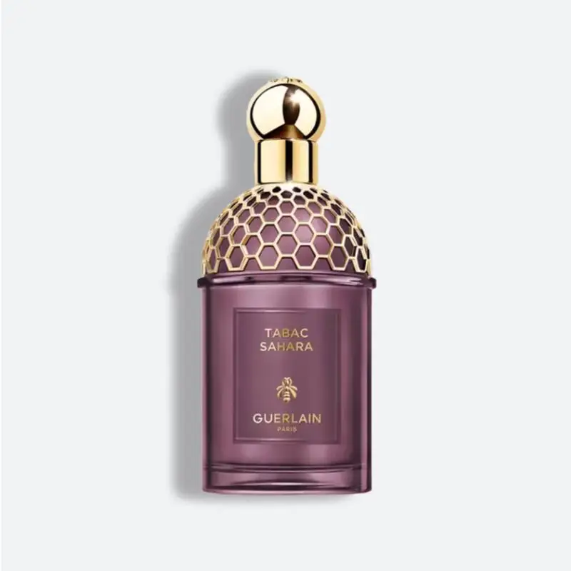 زجاجة عطر تاباك صحارى من جيرلان باريس باللون البنفسجي وغطاء ذهبي مزخرف